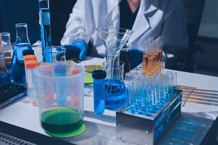 Scientist pipetting medical samples into microplate in laboratoryの写真素材