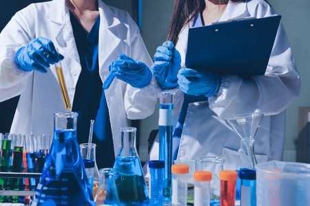 Scientist pipetting medical samples into microplate in laboratoryの写真素材
