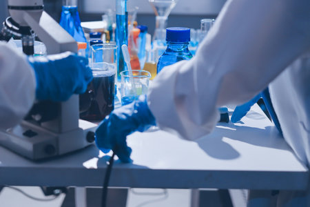 Scientist pipetting medical samples into microplate in laboratoryの写真素材