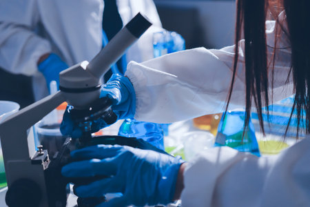 Scientist pipetting medical samples into microplate in laboratoryの写真素材