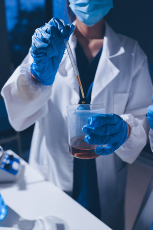 Scientist pipetting medical samples into microplate in laboratoryの写真素材