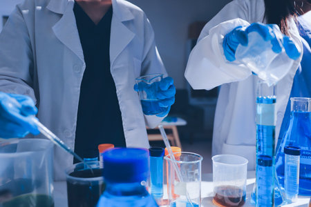 Scientist pipetting medical samples into microplate in laboratoryの写真素材