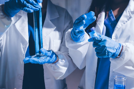 Scientist pipetting medical samples into microplate in laboratoryの写真素材