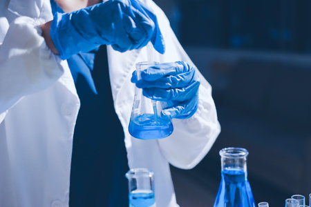 Scientist pipetting medical samples into microplate in laboratoryの写真素材