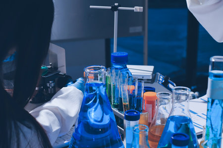 Scientist pipetting medical samples into microplate in laboratoryの写真素材