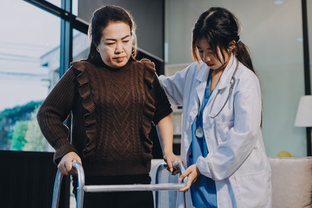 Young doctor examines senior patient's legの写真素材