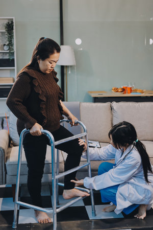 Young doctor examines senior patient's legの写真素材