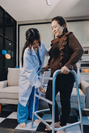 Young doctor examines senior patient's legの写真素材