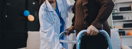 Young doctor examines senior patient's legの写真素材