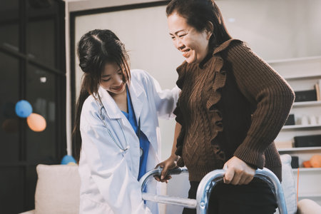 Young doctor examines senior patient's legの写真素材
