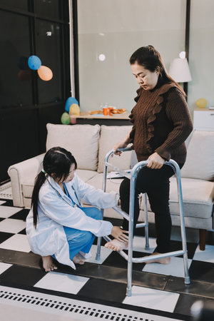 Young doctor examines senior patient's legの写真素材