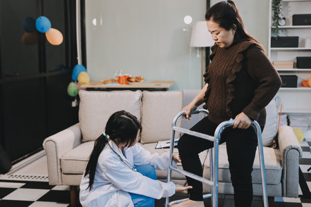 Young doctor examines senior patient's legの写真素材