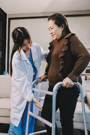 Young doctor examines senior patient's legの写真素材