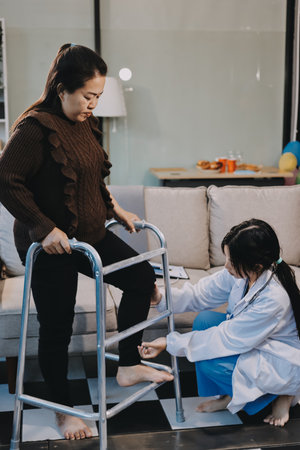 Young doctor examines senior patient's legの写真素材
