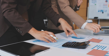 Accounting company provide finance and taxation planning for profitable cash flow, Auditor and accountant team working in office, analyze financial data and accounting record with calculator.Insightの写真素材