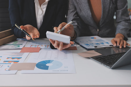 Accounting company provide finance and taxation planning for profitable cash flow, Auditor and accountant team working in office, analyze financial data and accounting record with calculator.Insightの写真素材