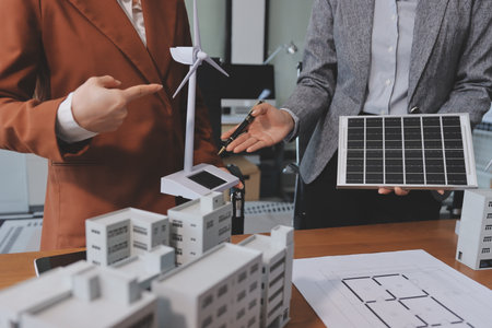 Discussion among businesspeople on the latest developments in solar cell panel technology and Solar Energy Environment city Concept.の写真素材