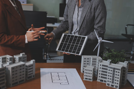 Discussion among businesspeople on the latest developments in solar cell panel technology and Solar Energy Environment city Concept.の写真素材