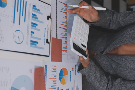 Accounting company provide finance and taxation planning for profitable cash flow, Auditor and accountant team working in office, analyze financial data and accounting record with calculator.Insightの写真素材