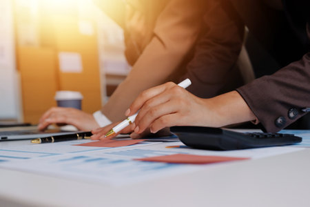 Accounting company provide finance and taxation planning for profitable cash flow, Auditor and accountant team working in office, analyze financial data and accounting record with calculator.Insightの写真素材
