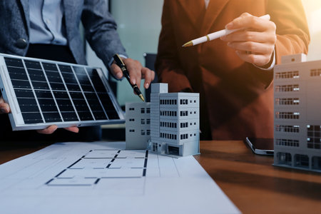Discussion among businesspeople on the latest developments in solar cell panel technology and Solar Energy Environment city Concept.の写真素材