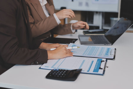 Accounting company provide finance and taxation planning for profitable cash flow, Auditor and accountant team working in office, analyze financial data and accounting record with calculator.Insightの写真素材