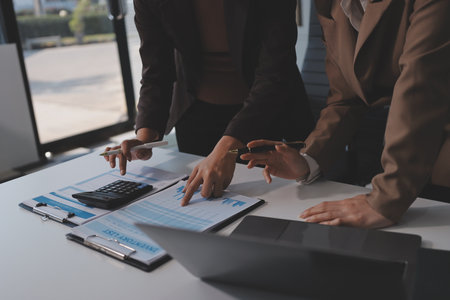 Accounting company provide finance and taxation planning for profitable cash flow, Auditor and accountant team working in office, analyze financial data and accounting record with calculator.Insightの写真素材