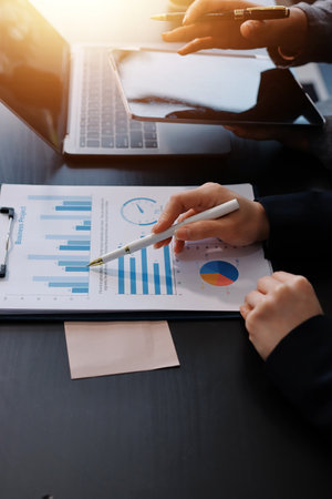 Accounting company provide finance and taxation planning for profitable cash flow, Auditor and accountant team working in office, analyze financial data and accounting record with calculator.Insightの写真素材