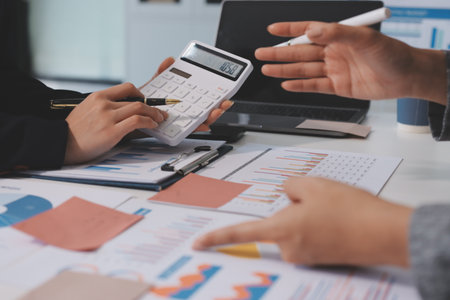 Accounting company provide finance and taxation planning for profitable cash flow, Auditor and accountant team working in office, analyze financial data and accounting record with calculator.Insightの写真素材