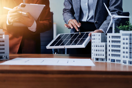 Discussion among businesspeople on the latest developments in solar cell panel technology and Solar Energy Environment city Concept.の写真素材