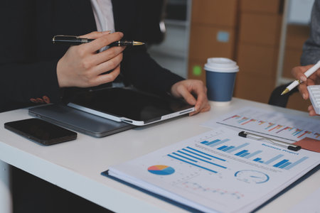 Accounting company provide finance and taxation planning for profitable cash flow, Auditor and accountant team working in office, analyze financial data and accounting record with calculator.Insightの写真素材