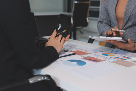 Accounting company provide finance and taxation planning for profitable cash flow, Auditor and accountant team working in office, analyze financial data and accounting record with calculator.Insightの写真素材