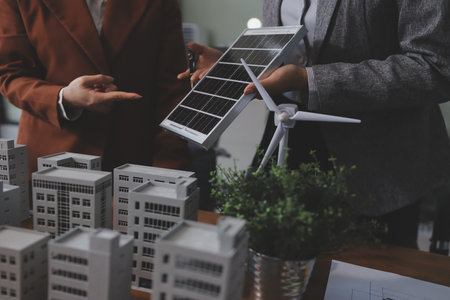 Discussion among businesspeople on the latest developments in solar cell panel technology and Solar Energy Environment city Concept.の写真素材
