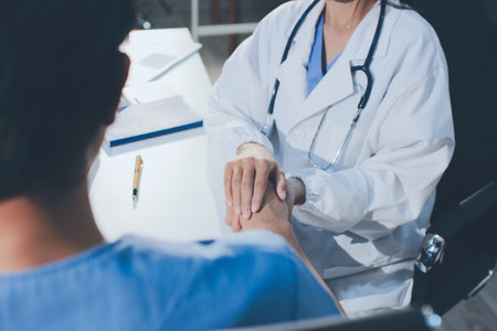 Doctor came to check the patient and shook his hand to encourage. Comforting the sick and treating the best, cured in the hospital.の写真素材
