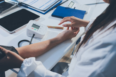 Doctor checking patient arterial blood pressure in hospital. Health care Conceptの写真素材