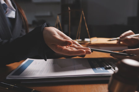Attractive young lawyer in office Business woman and lawyers discussing contract papers with brass...