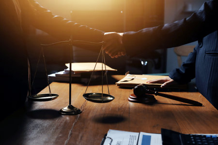 Attractive young lawyer in office Business woman and lawyers discussing contract papers with brass scale on wooden desk in office. Law, legal services, advice, Justice and real estate concept.の写真素材