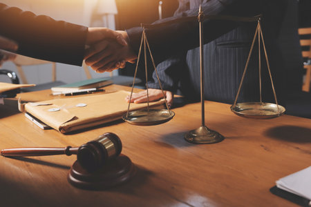 Attractive young lawyer in office Business woman and lawyers discussing contract papers with brass scale on wooden desk in office. Law, legal services, advice, Justice and real estate concept.の写真素材