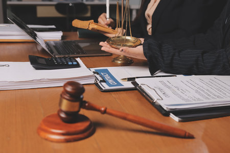 Attractive young lawyer in office Business woman and lawyers discussing contract papers with brass...