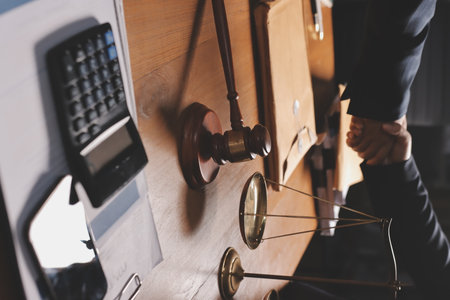 Attractive young lawyer in office Business woman and lawyers discussing contract papers with brass scale on wooden desk in office. Law, legal services, advice, Justice and real estate concept.の写真素材