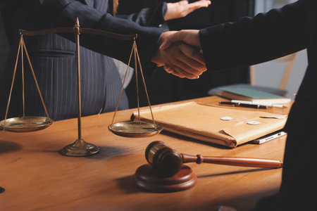 Attractive young lawyer in office Business woman and lawyers discussing contract papers with brass scale on wooden desk in office. Law, legal services, advice, Justice and real estate concept.の写真素材