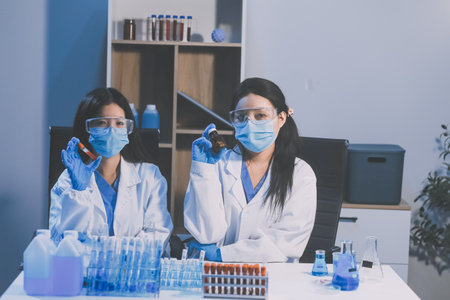 Research, experiment and medical trial being done by a scientist in a lab, science facility or hospital. One young, serious and professional researcher organizing, sorting or making a discoveryの写真素材