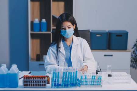 Research, experiment and medical trial being done by a scientist in a lab, science facility or hospital. One young, serious and professional researcher organizing, sorting or making a discoveryの写真素材