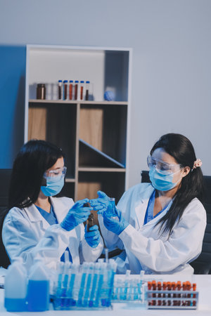 Research, experiment and medical trial being done by a scientist in a lab, science facility or hospital. One young, serious and professional researcher organizing, sorting or making a discoveryの写真素材