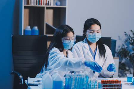 Research, experiment and medical trial being done by a scientist in a lab, science facility or hospital. One young, serious and professional researcher organizing, sorting or making a discoveryの写真素材