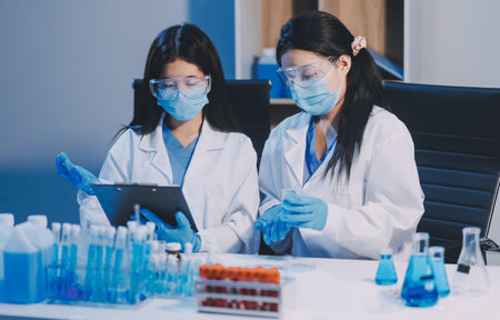 Research, experiment and medical trial being done by a scientist in a lab, science facility or hospital. One young, serious and professional researcher organizing, sorting or making a discoveryの写真素材