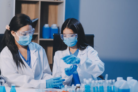 Research, experiment and medical trial being done by a scientist in a lab, science facility or hospital. One young, serious and professional researcher organizing, sorting or making a discoveryの写真素材