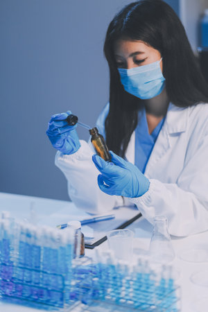 Research, experiment and medical trial being done by a scientist in a lab, science facility or hospital. One young, serious and professional researcher organizing, sorting or making a discoveryの写真素材