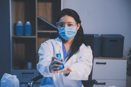 Research, experiment and medical trial being done by a scientist in a lab, science facility or hospital. One young, serious and professional researcher organizing, sorting or making a discoveryの写真素材
