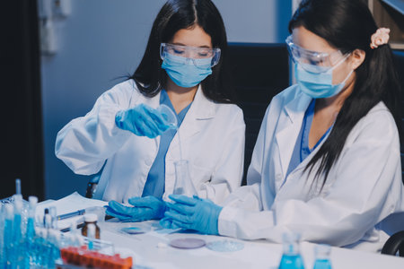 Research, experiment and medical trial being done by a scientist in a lab, science facility or hospital. One young, serious and professional researcher organizing, sorting or making a discoveryの写真素材